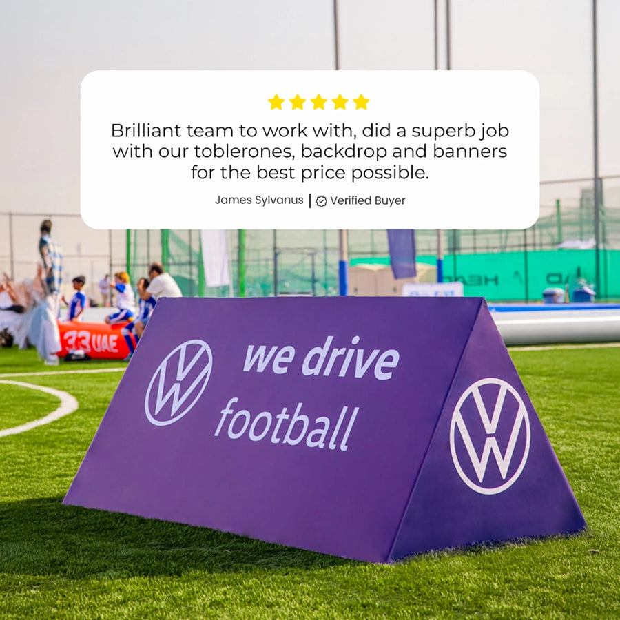 Purple branded sign on a football field with a customer review overlay.