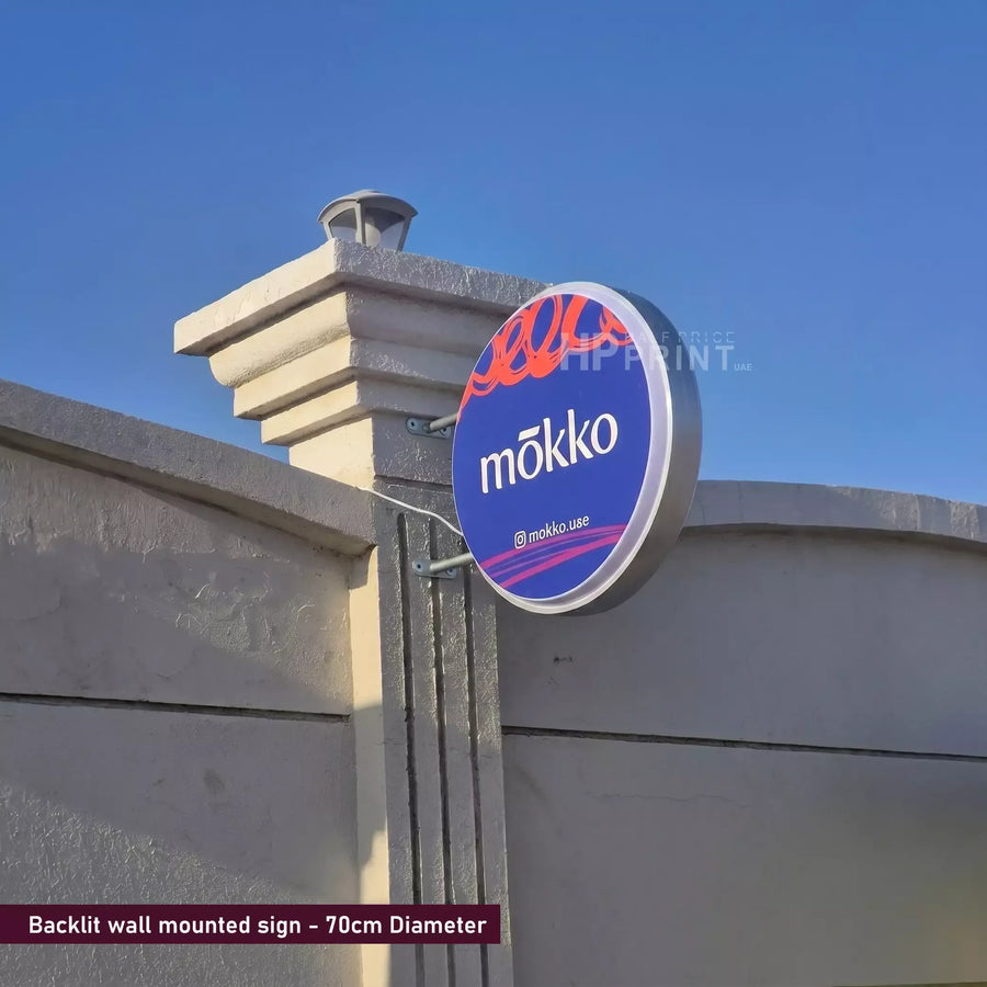 Mökko wall mounted sign on a wall with clear blue sky
