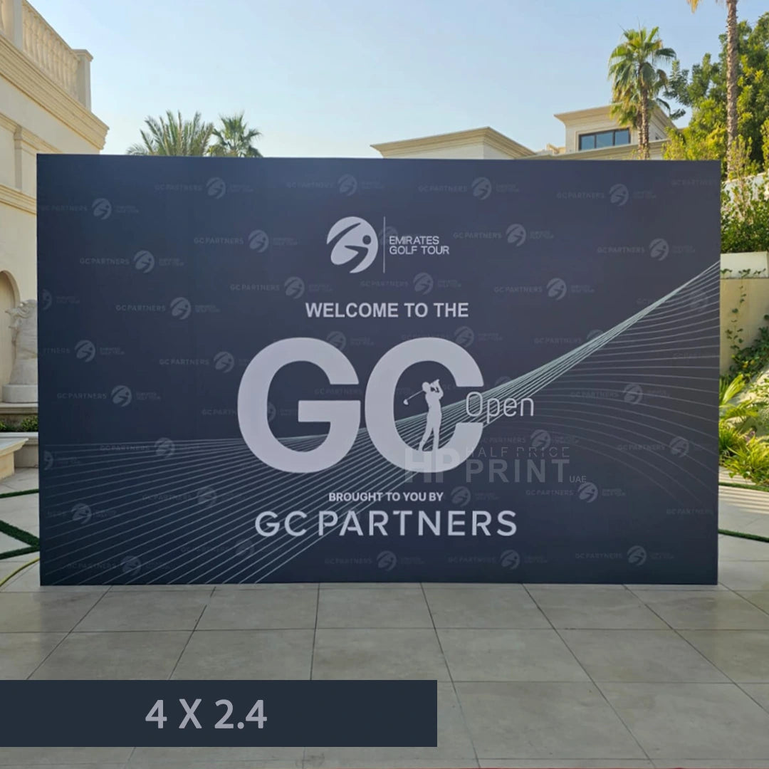 Large backdrop with Emirates Golf Tour branding and GC Open in an outdoor setting.